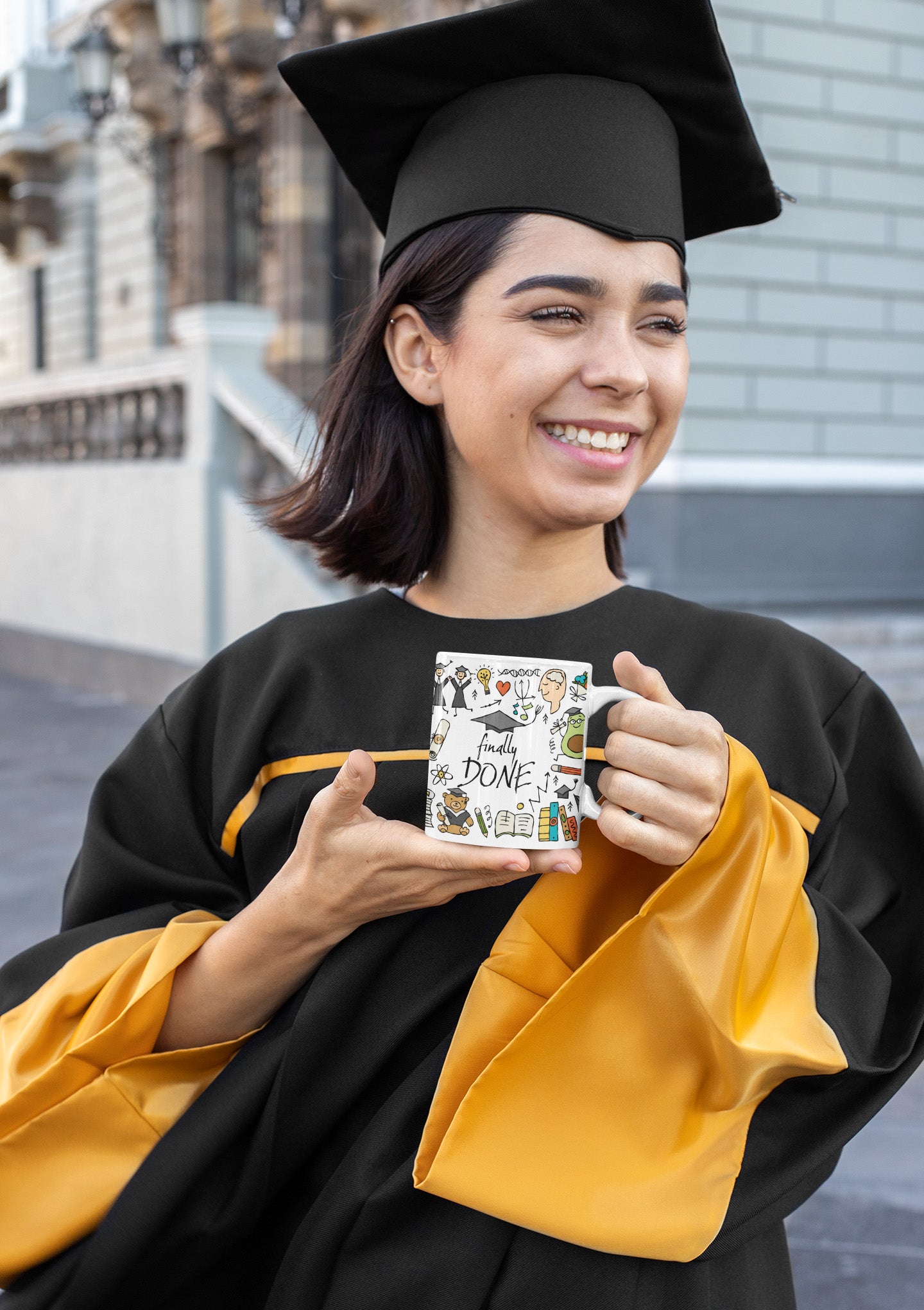 Grad girl with personalised 2023 graduation mug with funny designer print featuring graduates in hats and mantles, school books and holiday motifs and teddy bear