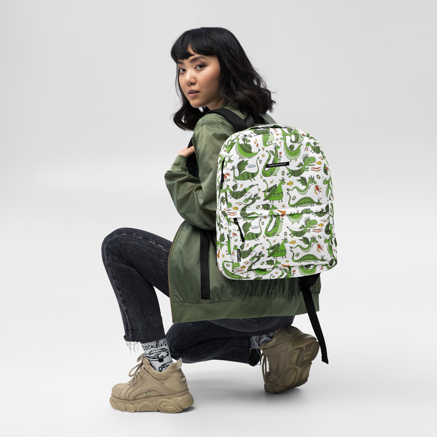 Asian Woman with Personalised Backpack with funny green Dragons. Basic text you can change - Dragonologist