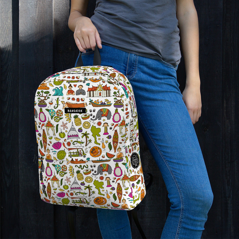 Woman hold personalised Backpack for travelers with bright designer print Thailand. Basic text you can change - Bangkok