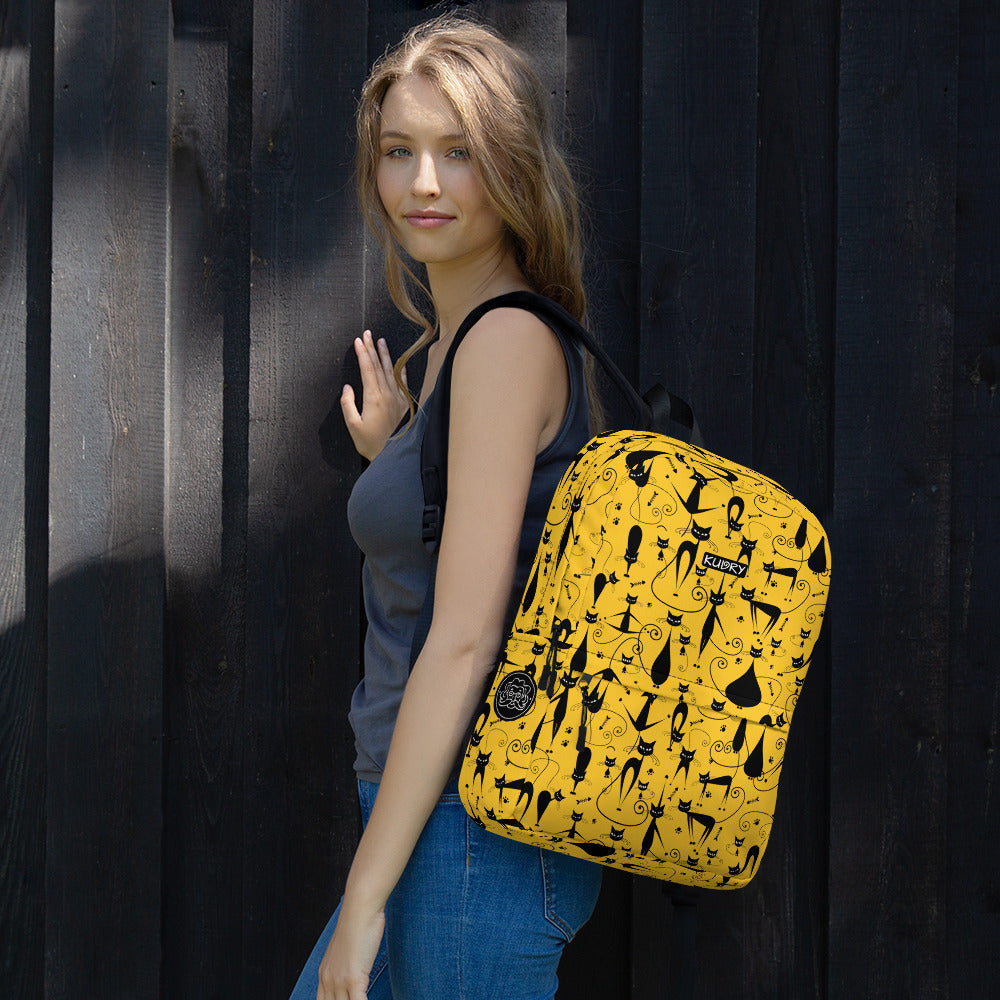 Young woman with yellow backpack with funny black cats family