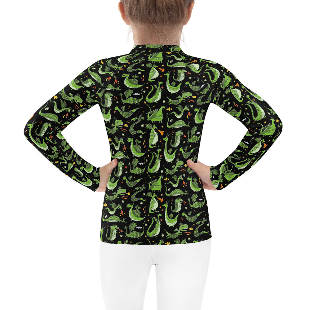 Little girl in Rash Guard black color with funny Green Dragons designer print. Back view