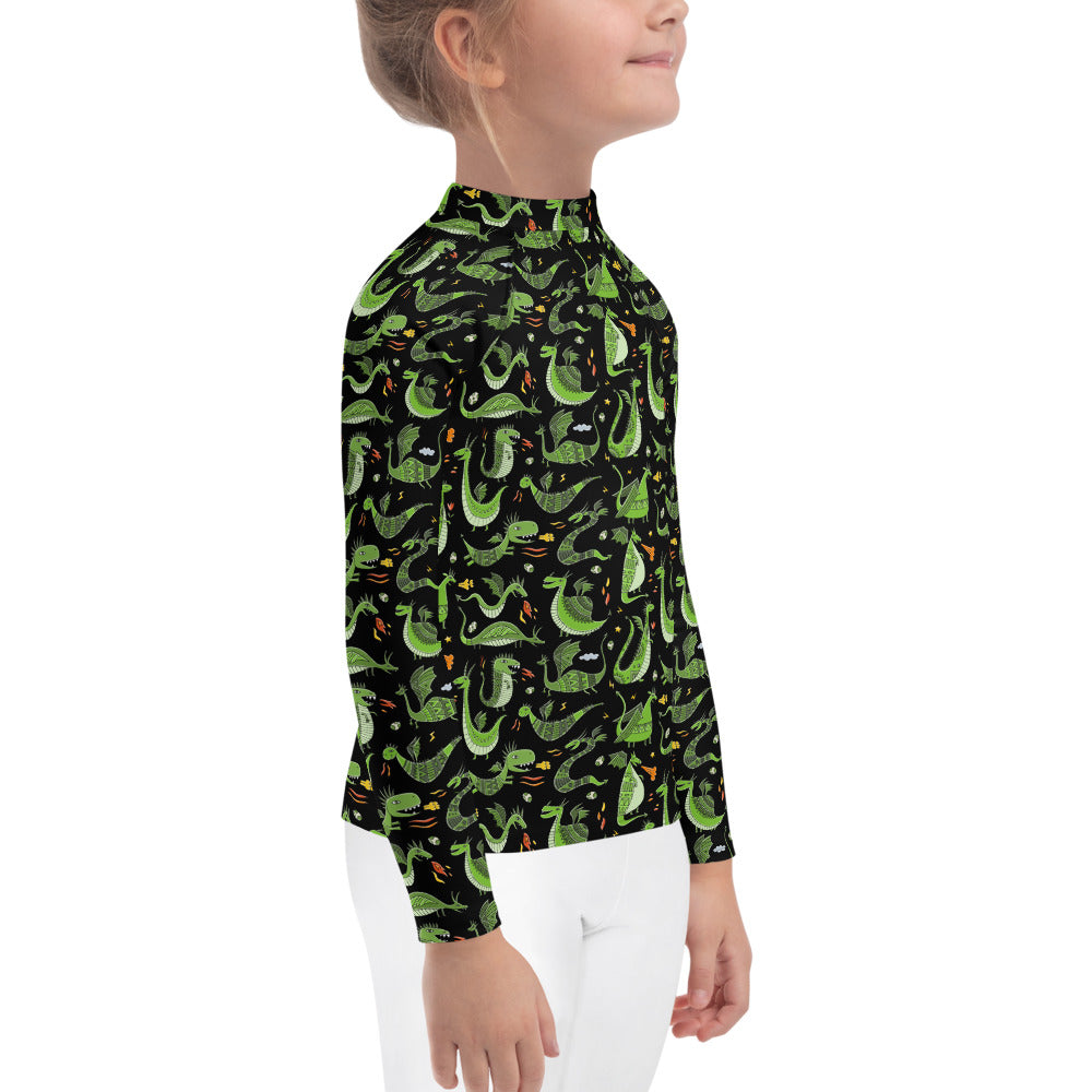 Little girl in Rash Guard black color with funny Green Dragons designer print. Right