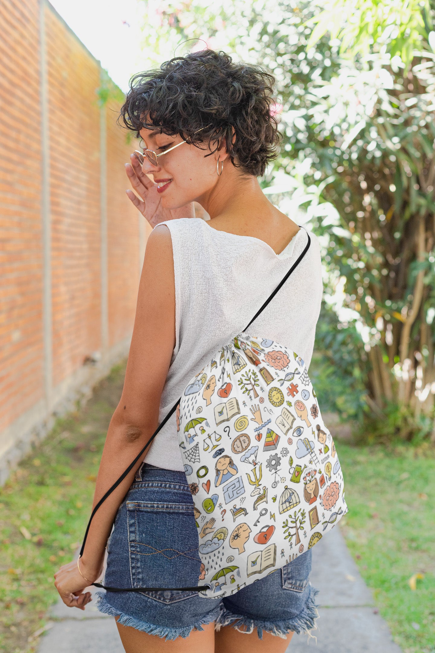 Drawstring bag with psychology print featuring a short haired girl looking over her shoulder