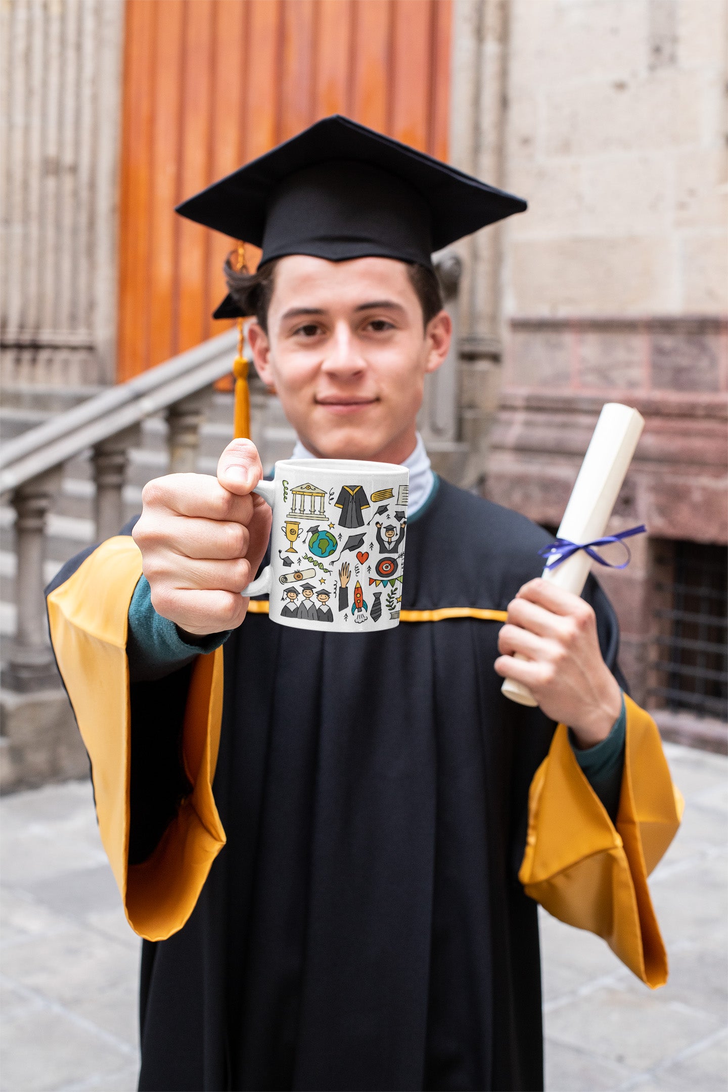 Grad boy with personalised 2023 graduation mug with funny designer print featuring graduates in hats and mantles, school books and holiday motifs and teddy bear
