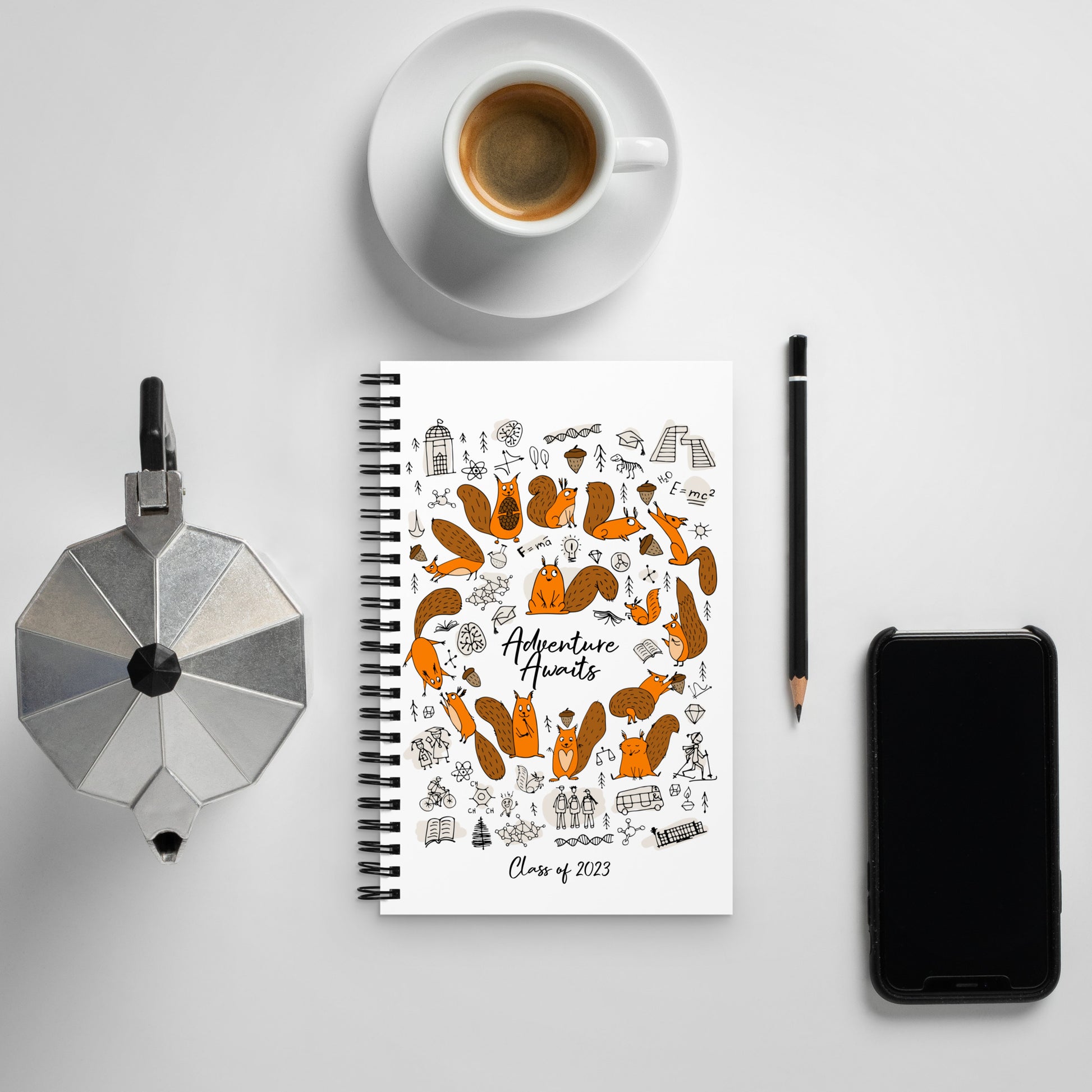 Spiral notebook white with funny science squirrels designer print with coffee and mobile phone on table
