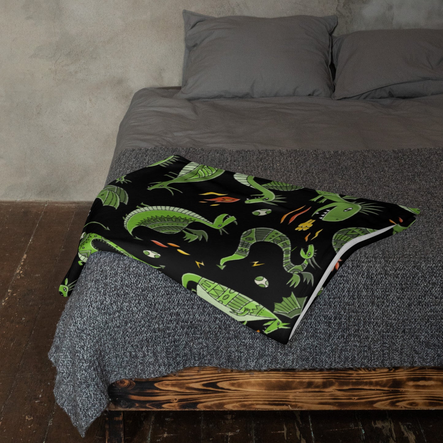 Black blanket 50х60 with funny green dragons on bed