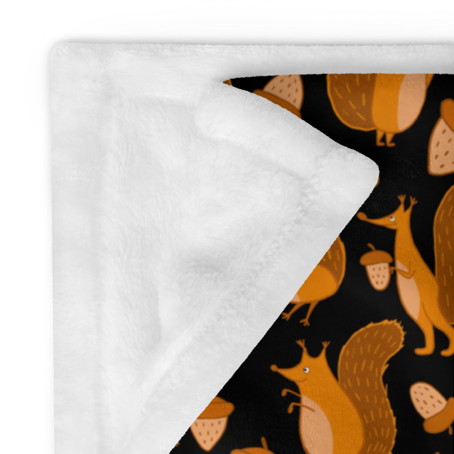 Throw blanket black color with funny orange squirrels and nuts. Reverse side of the blanket is white color